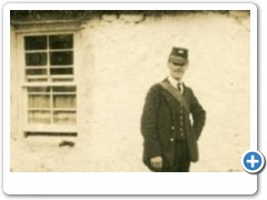 Postman by thatched house